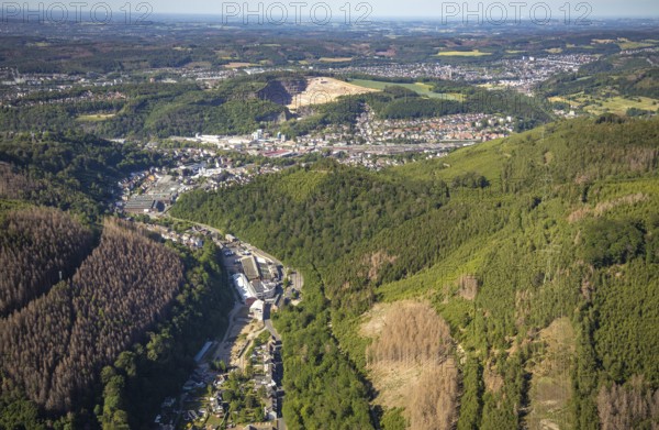 Aerial view, planned wind power plants, industrial area Obernahmerstraße, district Nahmer, quarry Steltenberg, Hagen-Hohenlimburg, Ruhr area, North Rhine-Westphalia, Germany, forestation, DE, Europe, distant view, commercial enterprises, commercial area, commercial site, commercial use, Hagen, Hohenlimburger Kalkwerke GmbH, hilly landscape, industrial area, industrial site, landscape conservation area, aerial view, aerial photography, aerial photography, nature conservation, nature reserve, quarry, open-cast mine, valley, overview, bird's-eye view, forest, forest area, forest damage, forest dieback, birds-eyes view, overview, thyssenkrupp Hohenlimburg GmbH