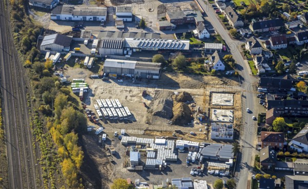 Aerial view, construction site new building flats, former company premises Klostermann, Annabergstraße, Haltern-Stadt, Haltern am See, Ruhr area, North Rhine-Westphalia, Germany, construction work, construction, construction area, building site, building plots, construction crane, construction project, construction site, Buses, DE, Europe, aerial view, aerial photography, aerial photography, new building, photovoltaic, photovoltaic plant, recycling yard, solar, solar plant, solar energy, solar energy, overview, bird's-eye view, birds-eyes view, overview, autumn, autumn leaves, golden October, autumnal