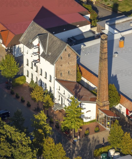 Aerial photograph, WEZ supermarket, stork's nest on the chimney of the Alte Kornbrennerei, Hille, Ostwestfalen-Lippe, OWL, North Rhine-Westphalia, Germany, Alte Brennerei, DE, shopping square, shopping centre, Europe, Hillerichs, industrial museum, Kornbrennerei Meyer, aerial photograph, aerial photography, aerial photography, Mindener Straße, museum, local shopping centre, nest, OWL book, OWLBuch, Ostwestfalenbuch, chimneys, shopping centre, StorchenLeben, supermarket, tower, overview, bird's-eye view, white storks, birds-eyes view, overview