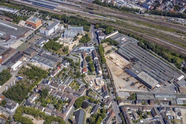 Aerial view, construction site on the WDI site between the railway embankment and Otto-Brenner-Straße, Hamm, Ruhr area, North Rhine-Westphalia, Germany, DE, Europe, birds-eyes, view, aerial view, aerial photography, aerial photography, overview, overview, bird's eye view, railway line, railway network, infrastructure, transport, train traffic, freight traffic, railway network, metal processing, metalworking, industry, production, workplaces