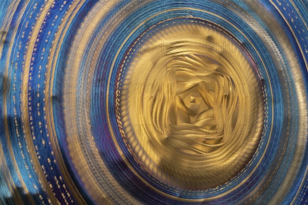 Full frame abstract closeup shot of a colorful metallic asian gong