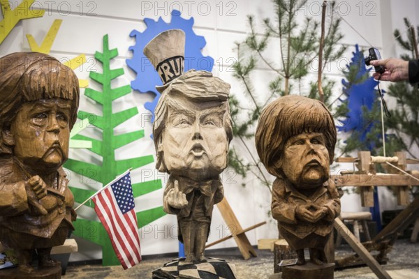 DEU Germany Germany Berlin The busts of U.S. President Donald Trump and Chancellor Angelika Merkel, made by a chainsaw artist, at the Green Week