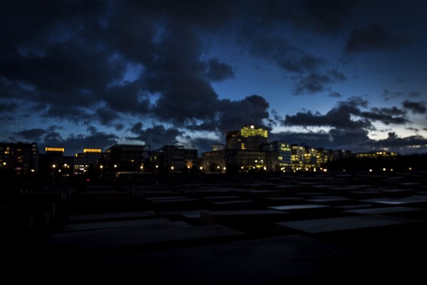 DEU Germany Germany Berlin The Holocaust Memorial at blue hour under a cloudy sky in the direction of Potsdamer Platz