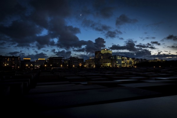 DEU Germany Germany Berlin The Holocaust Memorial at blue hour under a cloudy sky in the direction of Potsdamer Platz