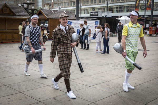 DEU Germany Germany Berlin A group of men in historical golf costumes on Alexanderplatz