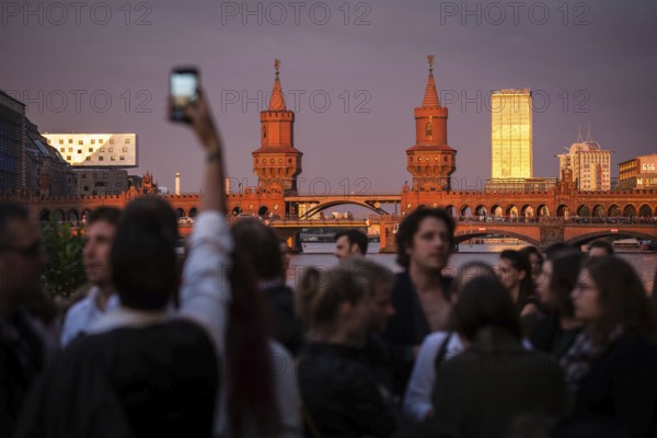 DEU Germany Germany Berlin Sunset on the terrace of the Fluxbau with the Oberbaum Bridge in the background