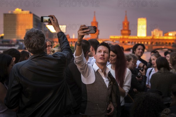 DEU Germany Germany Berlin Sunset on the terrace of the Fluxbau with the Oberbaum Bridge in the background