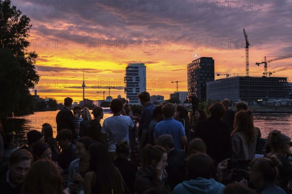 DEU Germany Germany Berlin Sunset on the terrace of the Fluxbau with the Oberbaum Bridge in the background