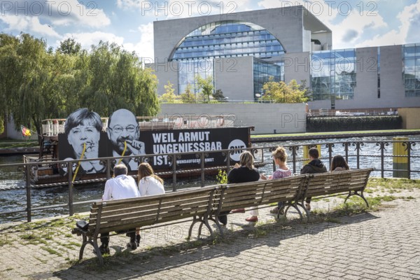 DEU Germany Germany Berlin Action by ONE on the Spree for the Bundestag elections. Protest against poverty with the confections of Merkel and Schulz drinking from the Spree with straws