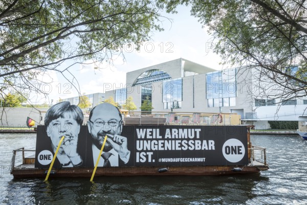 DEU Germany Germany Berlin Action by ONE on the Spree for the Bundestag elections. Protest against poverty with the likenesses of Merkel and Schulz drinking from the Spree with straws