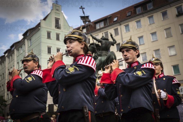 DEU Germany Germany Berlin A marching band with traditional uniforms marches through the Nikolai neighbourhood