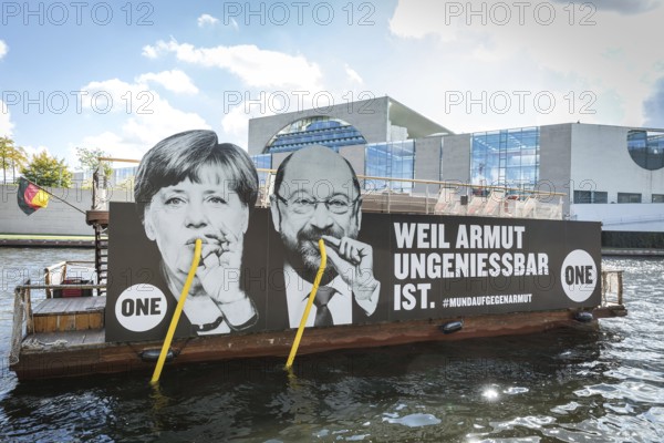 DEU Germany Germany Berlin Action by ONE on the Spree for the Bundestag elections. Protest against poverty with the confections of Merkel and Schulz drinking from the Spree with straws