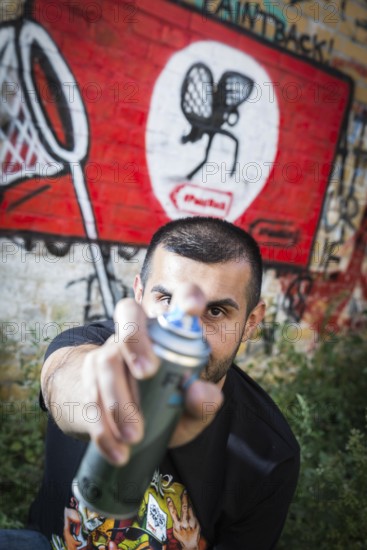 Germany Germany DEU Berlin Graffiti artist Ibo Omari in front of one of his works on a playground in Schöneberg