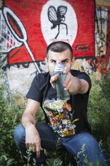 Germany Germany DEU Berlin Graffiti artist Ibo Omari in front of one of his works on a playground in Schöneberg