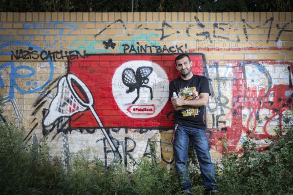 Germany Germany DEU Berlin Graffiti artist Ibo Omari in front of one of his works on a playground in Schöneberg