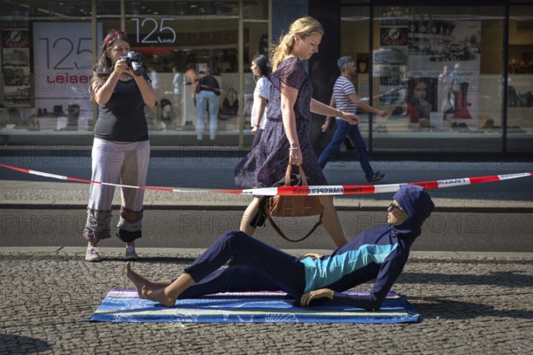 DEU Germany Germany Berlin A doll wearing a burkini lies at the entrance to the Französische Straße underground station on Friedrichsstrasse in Berlin-Mitte