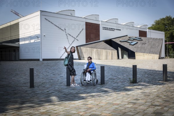 DEU Germany Germany Berlin Disabled tourist in a wheelchair explores Berlin with a city guide. Visit to the Jewish Museum