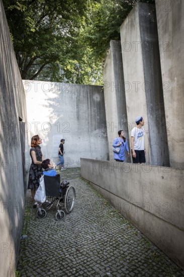 DEU Germany Germany Berlin Disabled tourist in a wheelchair explores Berlin with a city guide. Visit to the Jewish Museum