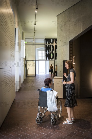 DEU Germany Germany Berlin Disabled tourist in a wheelchair explores Berlin with a city guide. Visit to the Jewish Museum