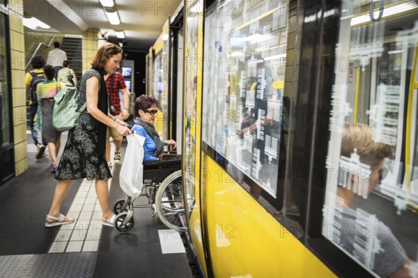 DEU Germany Germany Berlin Disabled tourist in a wheelchair explores Berlin with a city guide