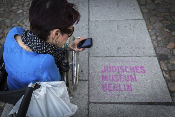 DEU Germany Germany Berlin Disabled tourist in a wheelchair explores Berlin with a city guide. Visit to the Jewish Museum