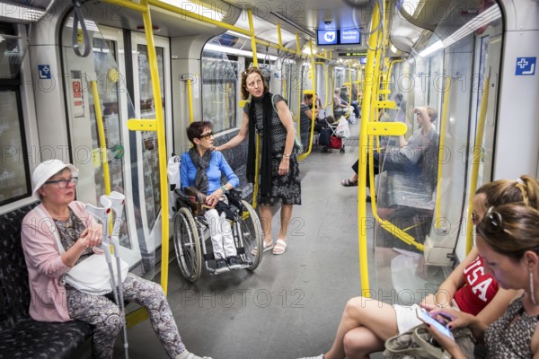 DEU Germany Germany Berlin Disabled tourist in a wheelchair explores Berlin with a city guide