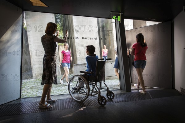 DEU Germany Germany Berlin Disabled tourist in a wheelchair explores Berlin with a city guide. Visit to the Jewish Museum