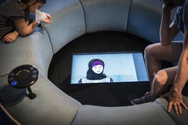 DEU Germany Germany Berlin Visitors watch an explanatory film on the subject of head coverings at the Jewish Museum