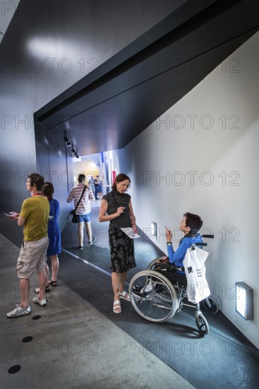 DEU Germany Germany Berlin Disabled tourist in a wheelchair explores Berlin with a city guide. Visit to the Jewish Museum