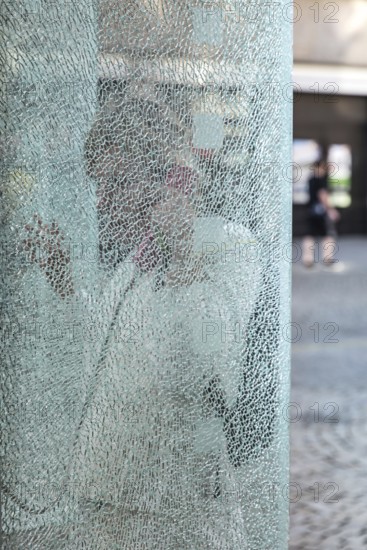DEU Germany Germany Berlin Woman talking on the phone at a phone box with shattered glass in Berlin-Spandau