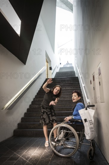 DEU Germany Germany Berlin Disabled tourist in a wheelchair explores Berlin with a city guide. Visit to the Jewish Museum