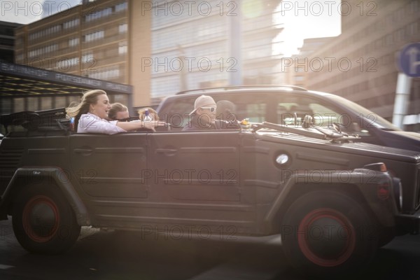 DEU Germany Germany Berlin Young people celebrating in a VW Kübelwagen on Potsdamer Platz