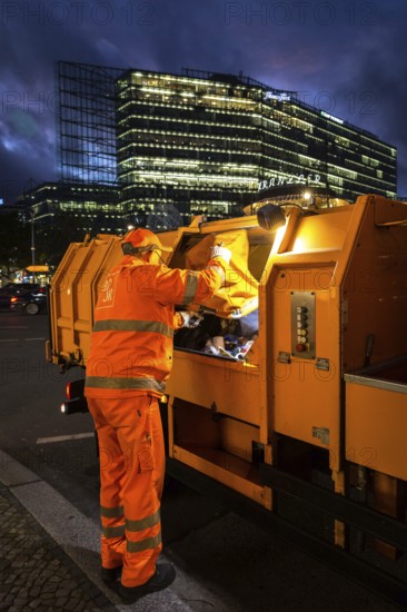 DEU Germany Germany Berlin A BSR employee unloads a rubbish bag in his vehicle on the Kudamm boulevard