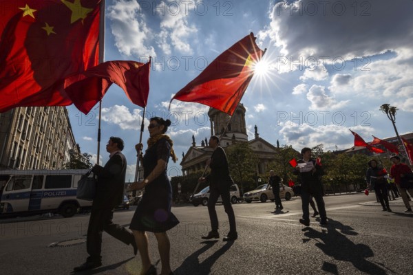 DEU Germany Germany Berlin A group with Chinese flags walks across the Gendarmenmarkt to demonstrate in favour of a peaceful solution to the conflict in Hong Kong