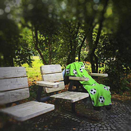 DEU Germany Germany Berlin A lonely blanket with football motifs lies abandoned on seats in a park in Wilmersdorf