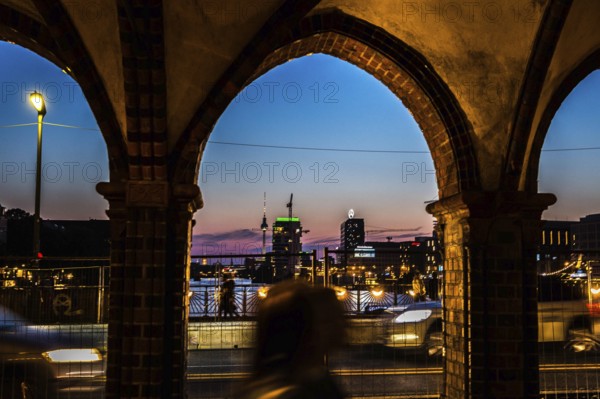 DEU Germany Germany Berlin Evening atmosphere seen through an arch of the Oberbaum Bridge
