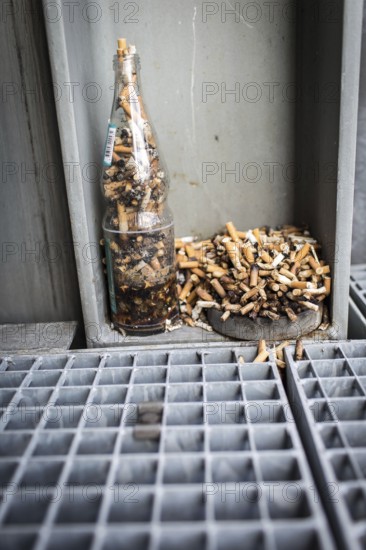 DEU Germany Germany Berlin Improvised ashtrays with cigarette butts on a balcony