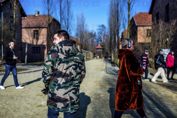 POL Poland Auschwitz Photo series about the memorial site of the former concentration camp Auschwitz-Birkenau. Visitor with camouflage jacket. POL Poland Auschwitz Scenes at the Holocaust Memorial .Visitor with camouflage jacket. Each year more than 2 million visitors are touring through the remains of the former German Nazi concentration and extermination camp Auschwitz-Birkenau. More than 1, 1 million people have been killed here between 1940 and 1945