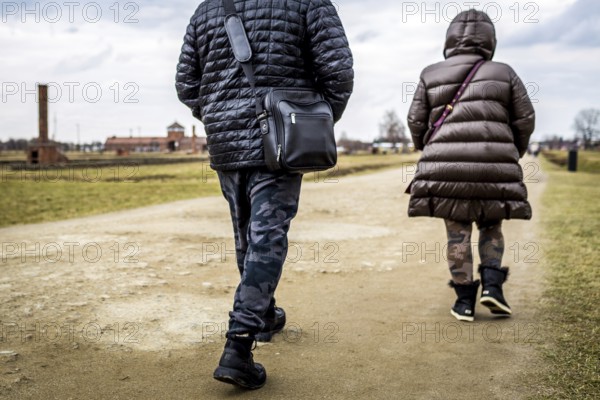 POL Poland Auschwitz Photo series about the memorial site of the former concentration camp Auschwitz-Birkenau. Visitors wearing camouflage trousers. POL Poland Auschwitz Scenes at the Holocaust Memorial .Visitors wearing camouflage trousers.Each year more than 2 million visitors are touring through the remains of the former German Nazi concentration and extermination camp Auschwitz-Birkenau. More than 1, 1 million people have been killed here between 1940 and 1945