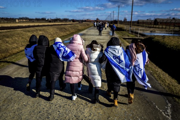 POL Poland Auschwitz Photo series about the memorial site of the former Auschwitz-Birkenau concentration camp. Israeli visitors with their flags on the way back. POL Poland Auschwitz Scenes at the Holocaust Memorial .Israeli visitors with their flags.Each year more than 2 million visitors are touring through the remains of the former German Nazi concentration and extermination camp Auschwitz-Birkenau. More than 1, 1 million people have been killed here between 1940 and 1945
