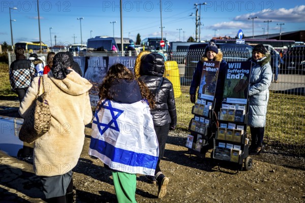 POL Poland Auschwitz Photo series about the memorial site of the former Auschwitz-Birkenau concentration camp. Israeli visitors with their flags passing Jehovah's Witnesses stand. POL Poland Auschwitz Scenes at the Holocaust Memorial .Israeli visitors with their flags passing Jehovah's witnesses.Each year more than 2 million visitors are touring through the remains of the former German Nazi concentration and extermination camp Auschwitz-Birkenau. More than 1, 1 million people have been killed here between 1940 and 1945