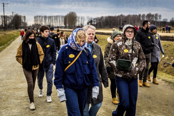 POL Poland Auschwitz Photo series about the memorial site of the former Auschwitz-Birkenau concentration camp. A group of visitors with yellow stickers of their tour agency. POL Poland Auschwitz Scenes at the Holocaust Memorial .Tourists with yellow stickers of their travel agency. Each year more than 2 million visitors are touring through the remains of the former German Nazi concentration and extermination camp Auschwitz-Birkenau. More than 1, 1 million people have been killed here between 1940 and 1945