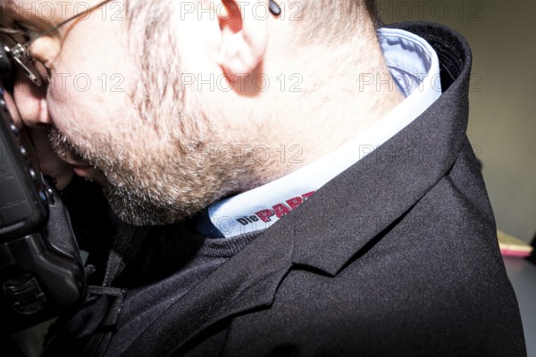 DEU Germany Germany Berlin Trial against Die Partei begins at the Berlin Administrative Court. The German Bundestag is demanding the return of subsidies that the satirists' party had received from the federal government through the 'Buy Money' campaign. Photographer with shirt bearing the 'Die Partei' logo
