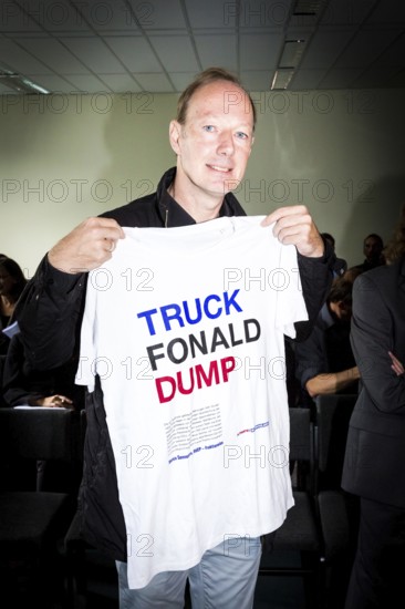 DEU Germany Germany Berlin Trial against Die Partei begins at the Berlin Administrative Court. The German Bundestag is demanding the return of subsidies that the satirists' party received from the federal government through the 'Buy Money' campaign. Martin Sonneborn with T-shirt against Trump and the EU