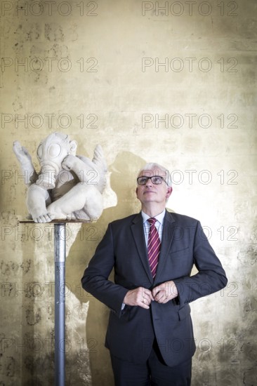 DEU Germany Germany Berlin The Managing Director of Deutsche Umwelthilfe, Jürgen Resch, next to a sculpture by sculptor Peter Lenk