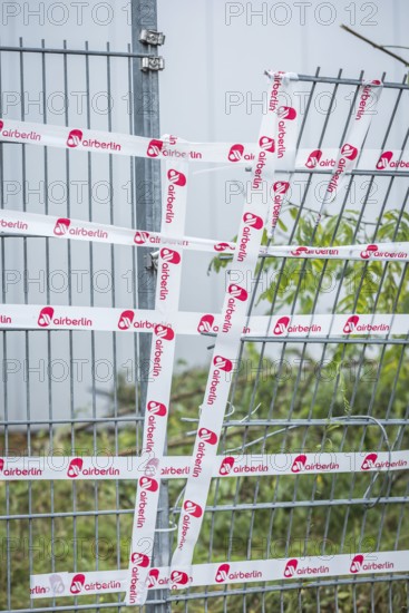 DEU Germany Germany Berlin The fence around an Air Berlin hangar on Saatwinkler Damm has been repaired with the airline's own adhesive tape. The airline will cease flight operations on 28 October