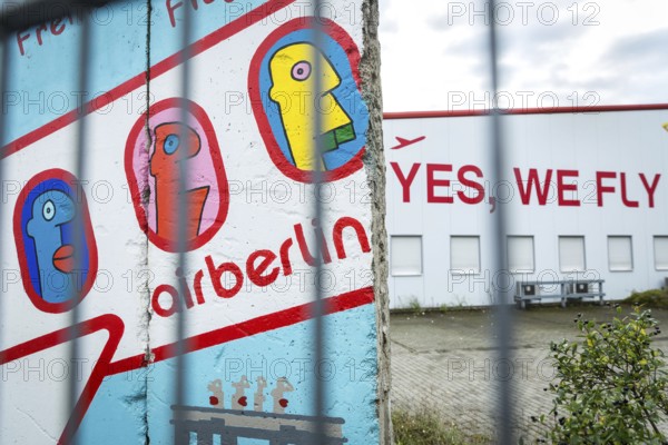 DEU Germany Germany Berlin A closed Air Berlin hangar with graffiti by Thierry Noir on pieces of the Berlin Wall on Saatwinkler Damm. The airline will cease operations on 28 October