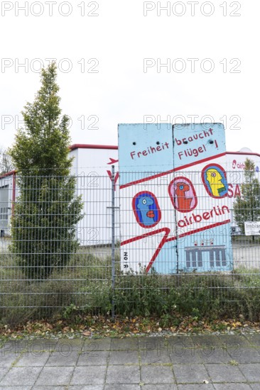 DEU Germany Germany Berlin A closed Air Berlin hangar with graffiti by Thierry Noir on pieces of the Berlin Wall on Saatwinkler Damm. The airline will cease operations on 28 October
