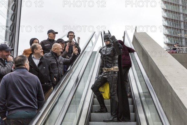 DEU Germany Germany Berlin A man wearing a Batman costume walks across Potsdamer Platz