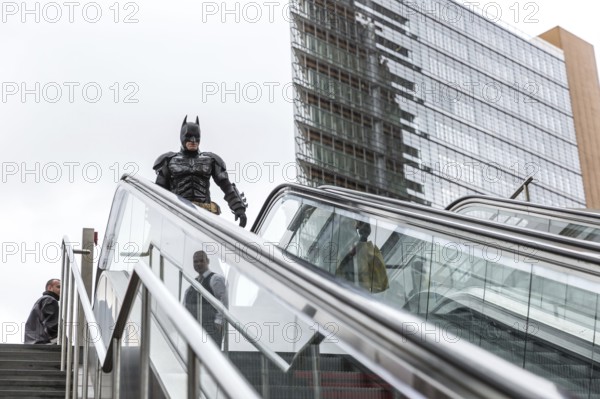DEU Germany Germany Berlin A man wearing a Batman costume walks across Potsdamer Platz